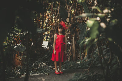 Full length portrait of girl standing outdoors