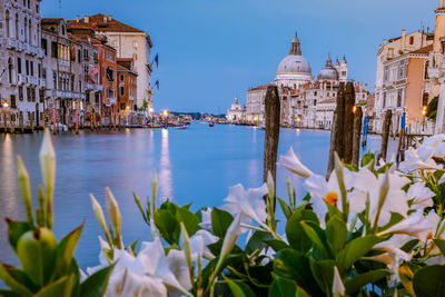 Panoramic view of canal amidst buildings against sky