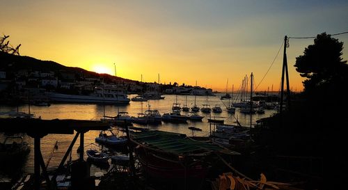 Sailboats in city at sunset