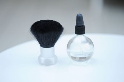 Close-up of make-up brush and perfume