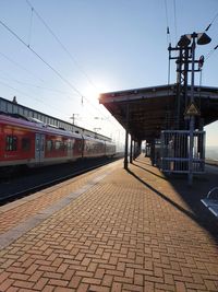 Train at railroad station against clear sky