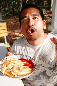 Portrait of young woman having food