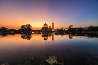 Reflection of temple in lake at sunset