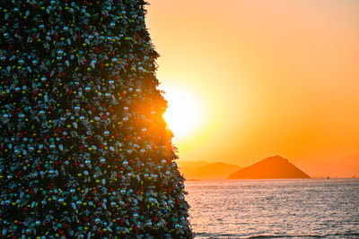 Scenic view of sea against orange sky