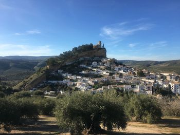 Buildings in town against sky