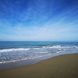 Scenic view of sea against blue sky
