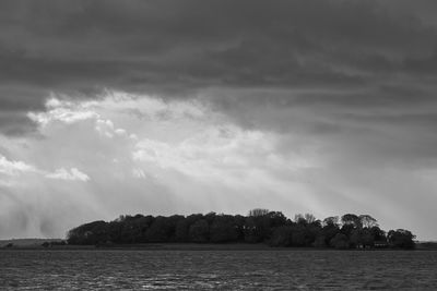 View of calm sea against cloudy sky