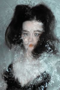 Close-up of young woman swimming in pool