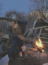 People sitting on wooden log