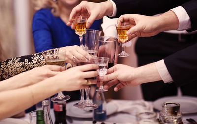 Close-up of hand holding beer glass