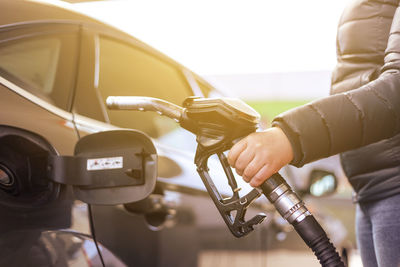 Midsection of woman repairing car