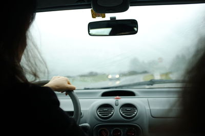 Cropped image of car moving on road
