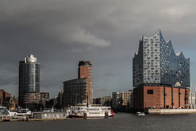 Modern buildings by city against sky