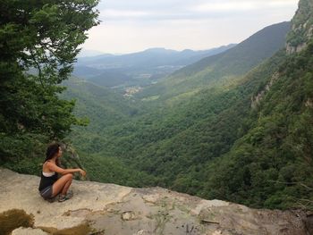 Woman sitting on a mountain