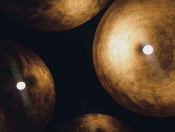 Low angle view of illuminated lights against sky at night