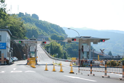 Road by mountain against sky