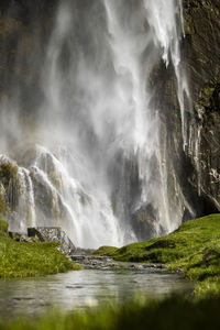 Waterfall cascading over rocks in a lush green nature landscape