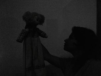 Side view of man and woman against wall