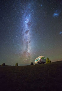Van against starry sky at night