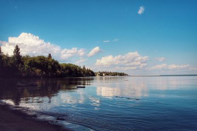 Scenic view of lake against blue sky