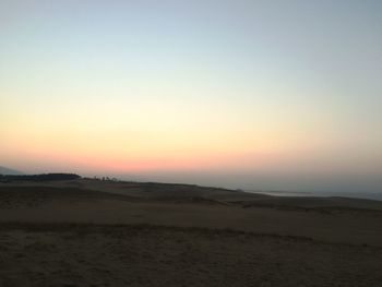 Scenic view of beach against sky during sunset