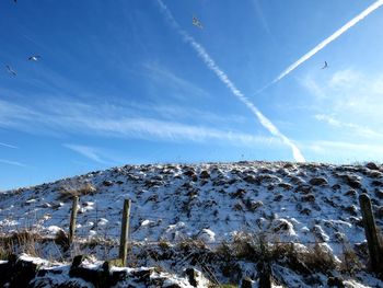 Low angle view of snowcapped mountain against sky