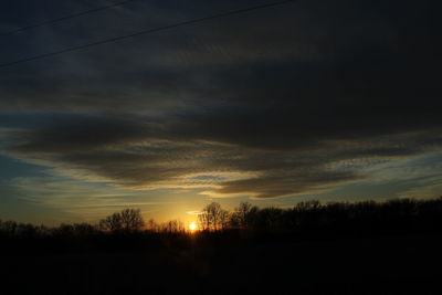 Silhouette trees against sky during sunset