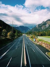 High angle view of road amidst mountains against cloudy sky