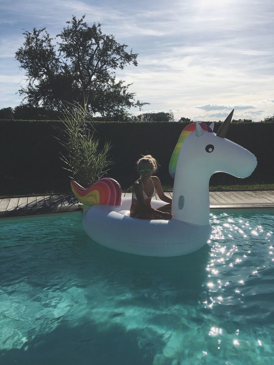 tree, waterfront, water, rippled, cloud, inflatable, tranquil scene, tranquility, blue, day, sky, ocean, calm, branch, scenics, inflatable ring, floating on water, nature, outdoors, swimming, sea, multi colored, hobbies, no people