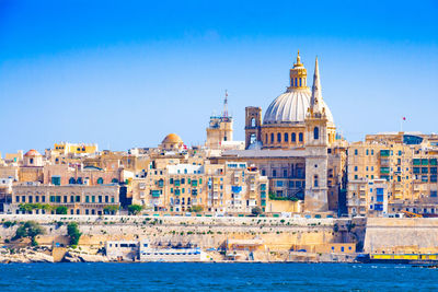 View of buildings against blue sky