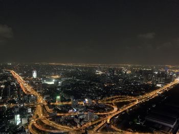 High angle view of illuminated city buildings at night