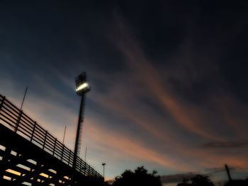 Low angle view of illuminated street light against sky during sunset