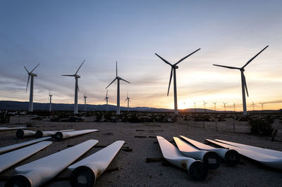 View of wind turbines against sky during sunset