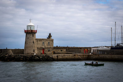 View of lighthouse in sea against sky