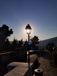Street light against clear sky at sunset