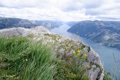 Scenic view of sea and mountains against sky