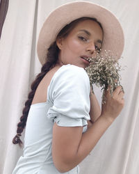 Side view of young woman looking at camera