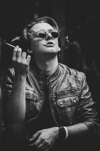 Man in sunglasses smoking cigarette