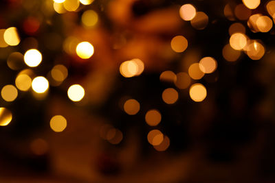 Defocused image of illuminated christmas lights at night