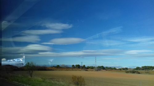 Scenic view of landscape against blue sky