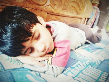 Girl sleeping on bed at home