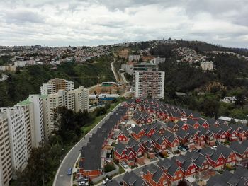 High angle view of urban skyline against cloudy sky