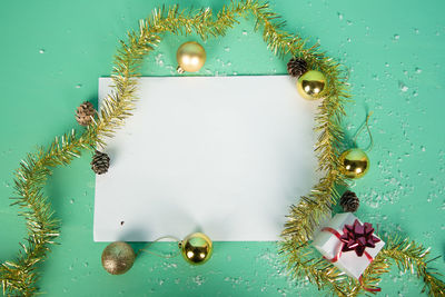 Close-up of christmas decoration on table against wall