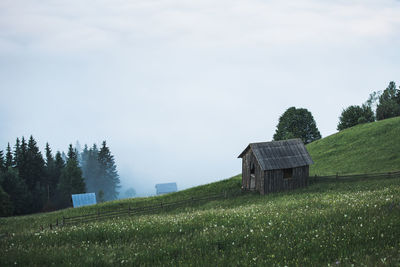 Built structure on field against sky