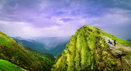 Scenic view of mountains against cloudy sky