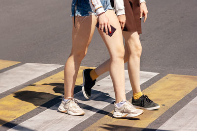 Low section of woman standing on street