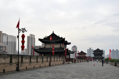 View of flags on beach against buildings