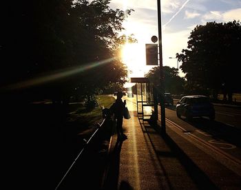 Silhouette of person on road in city