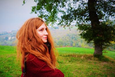 Portrait of smiling young woman on field