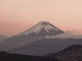 Scenic view of snowcapped mountains against sky during sunset